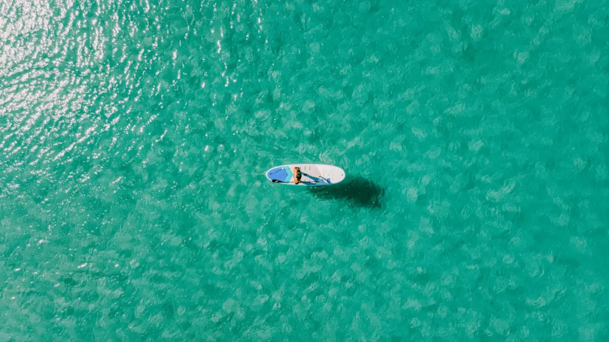 A boat on the water beside the shore at Kata