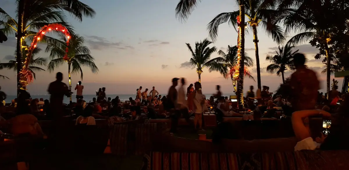 People gathered on Seminyak Beach at sunset