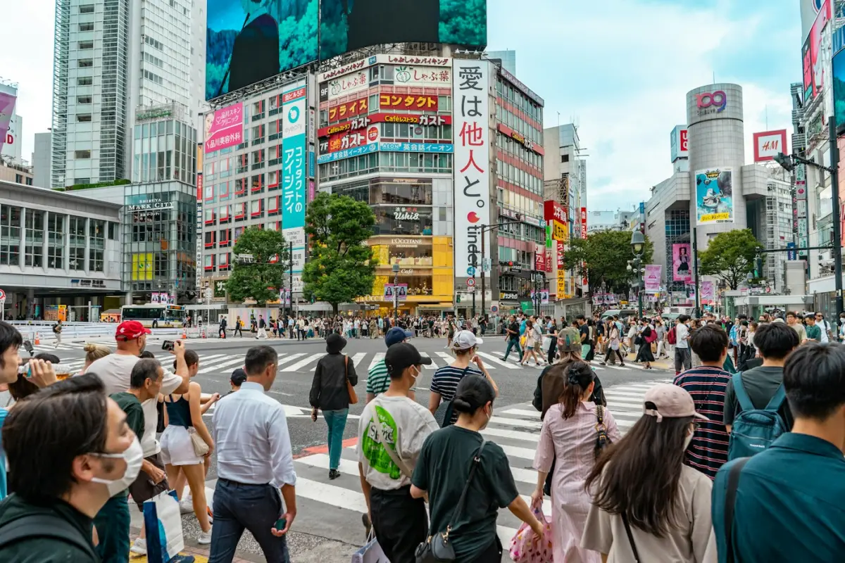 Pedestrians crossing a busy street in Shibuya, Tokyo