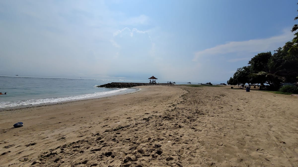 Sand and trees along the shore at Sanur Beach in Bali